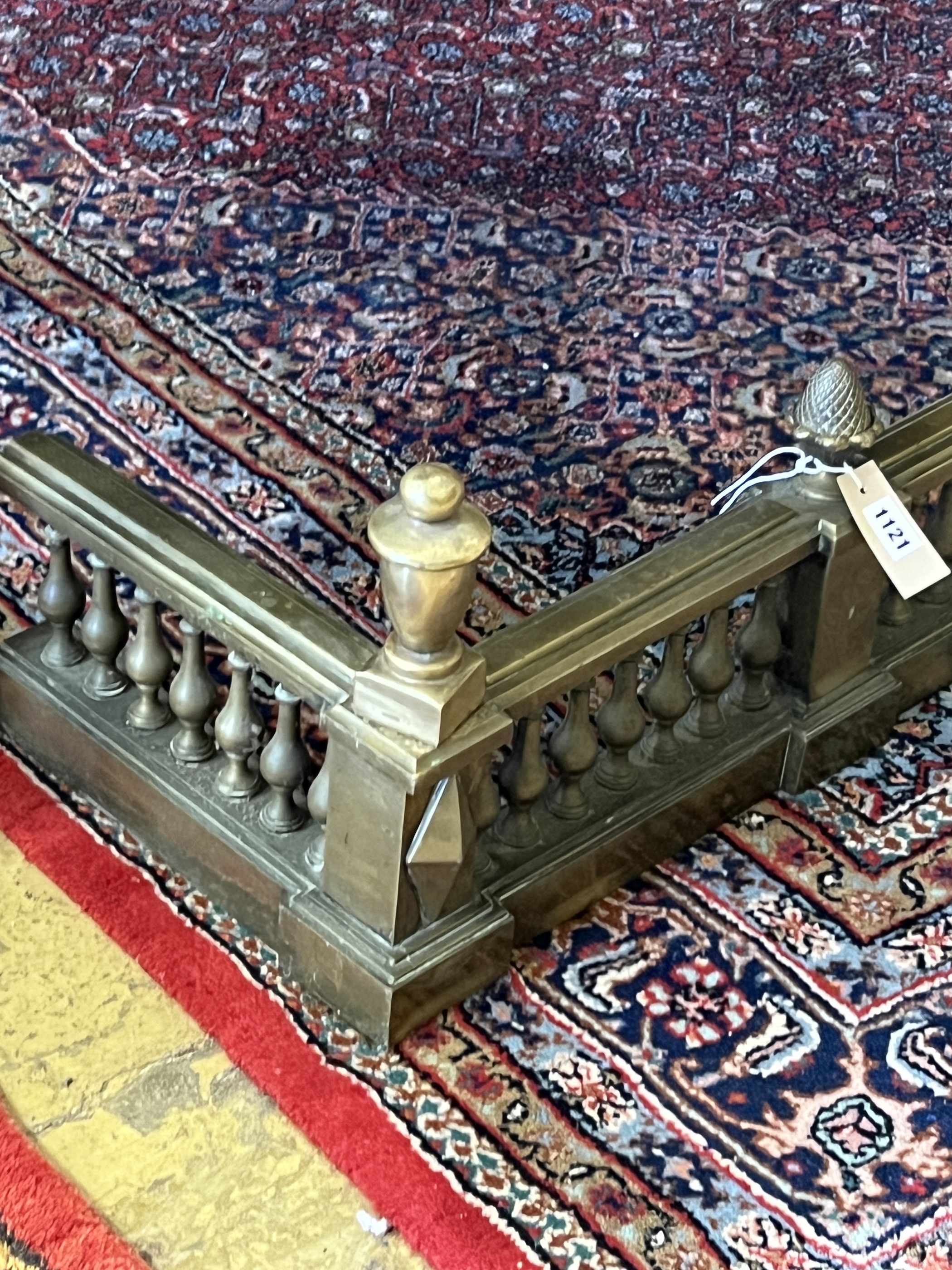 A large late Victorian cast brass fender, width 183cm, depth 32cm, height 30cm